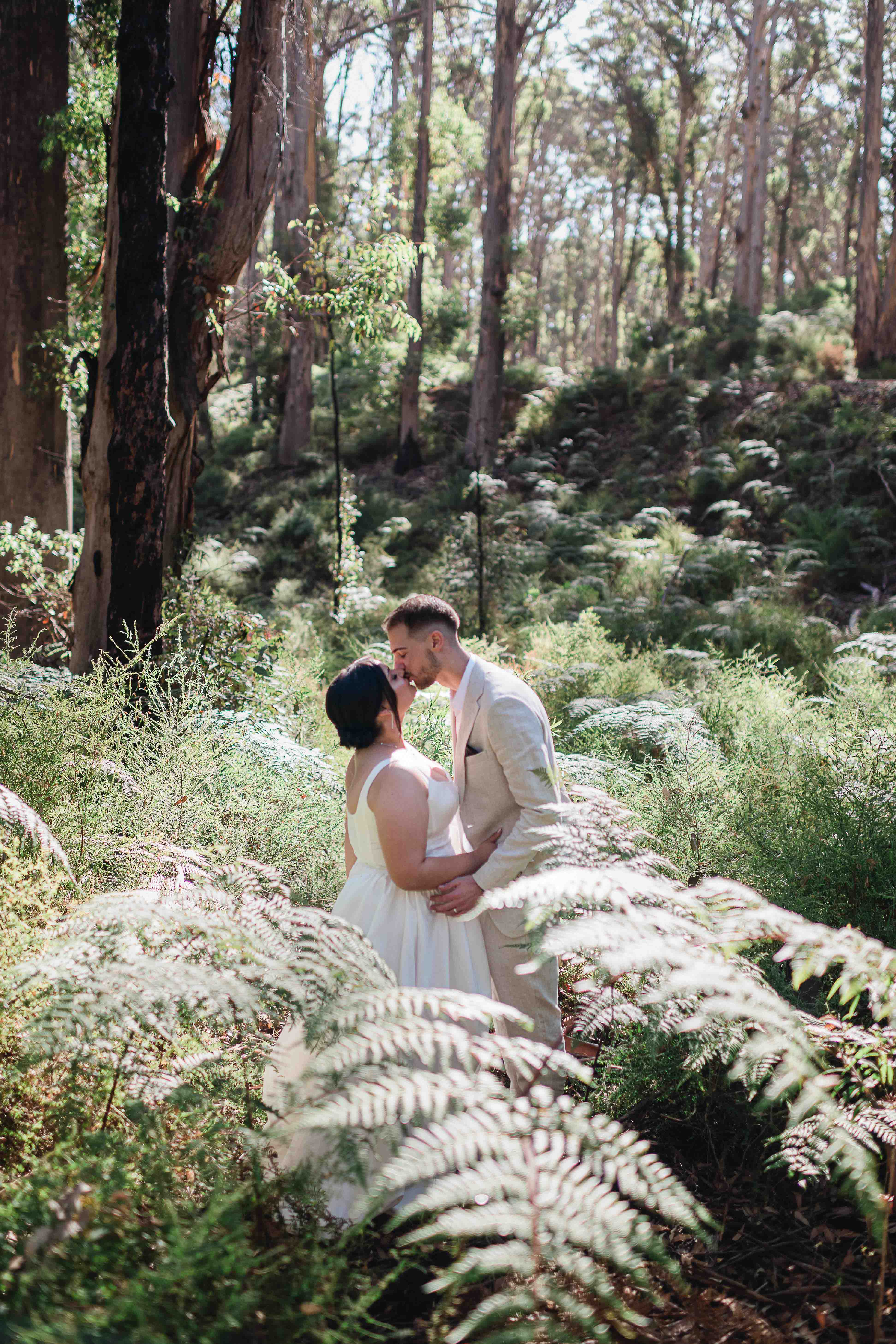 groom kisses bride in gorgeous natural light in boranup forest margaret river