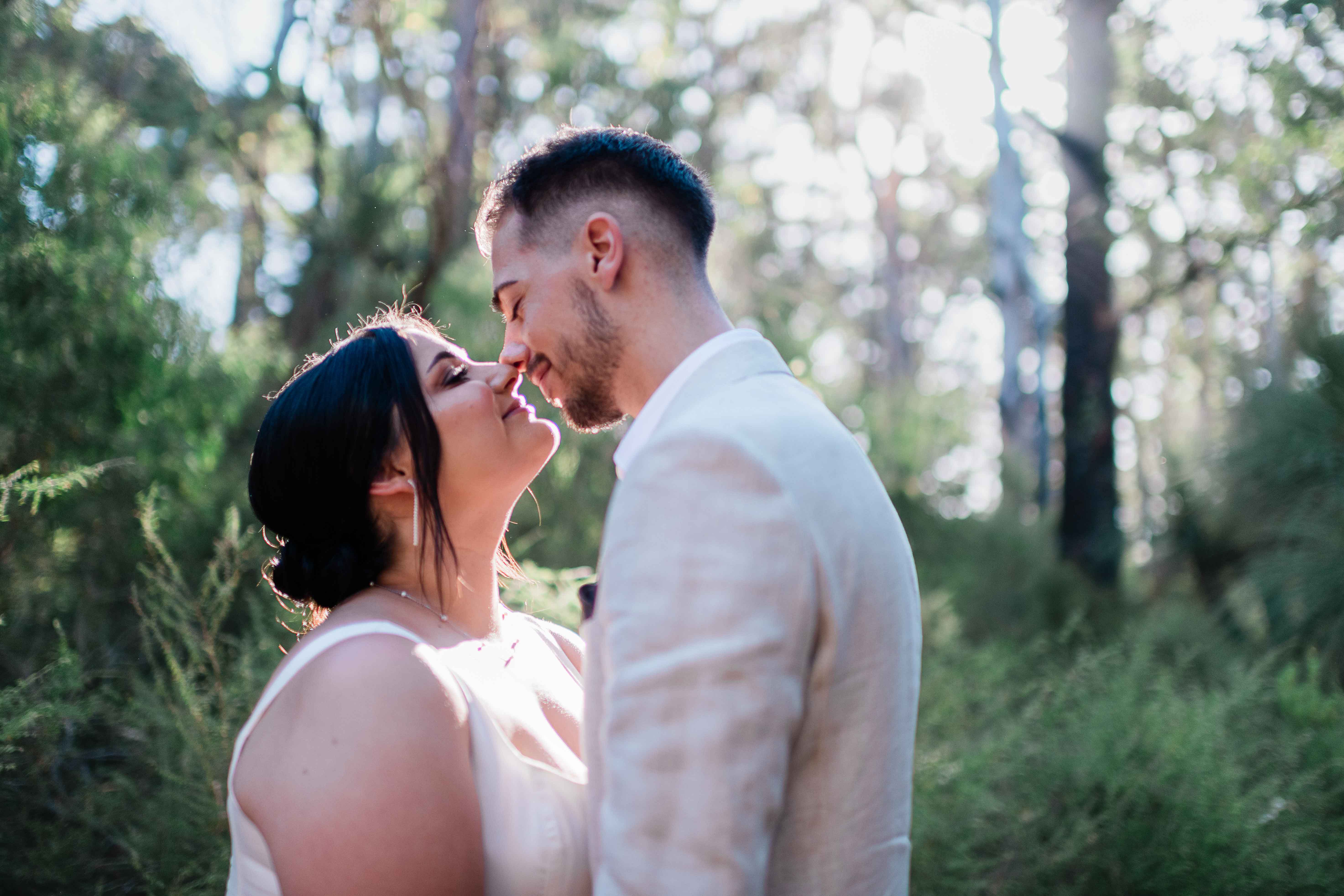 romantic bride and groom look into each others eyes just before kissing boranup forest epic remote location