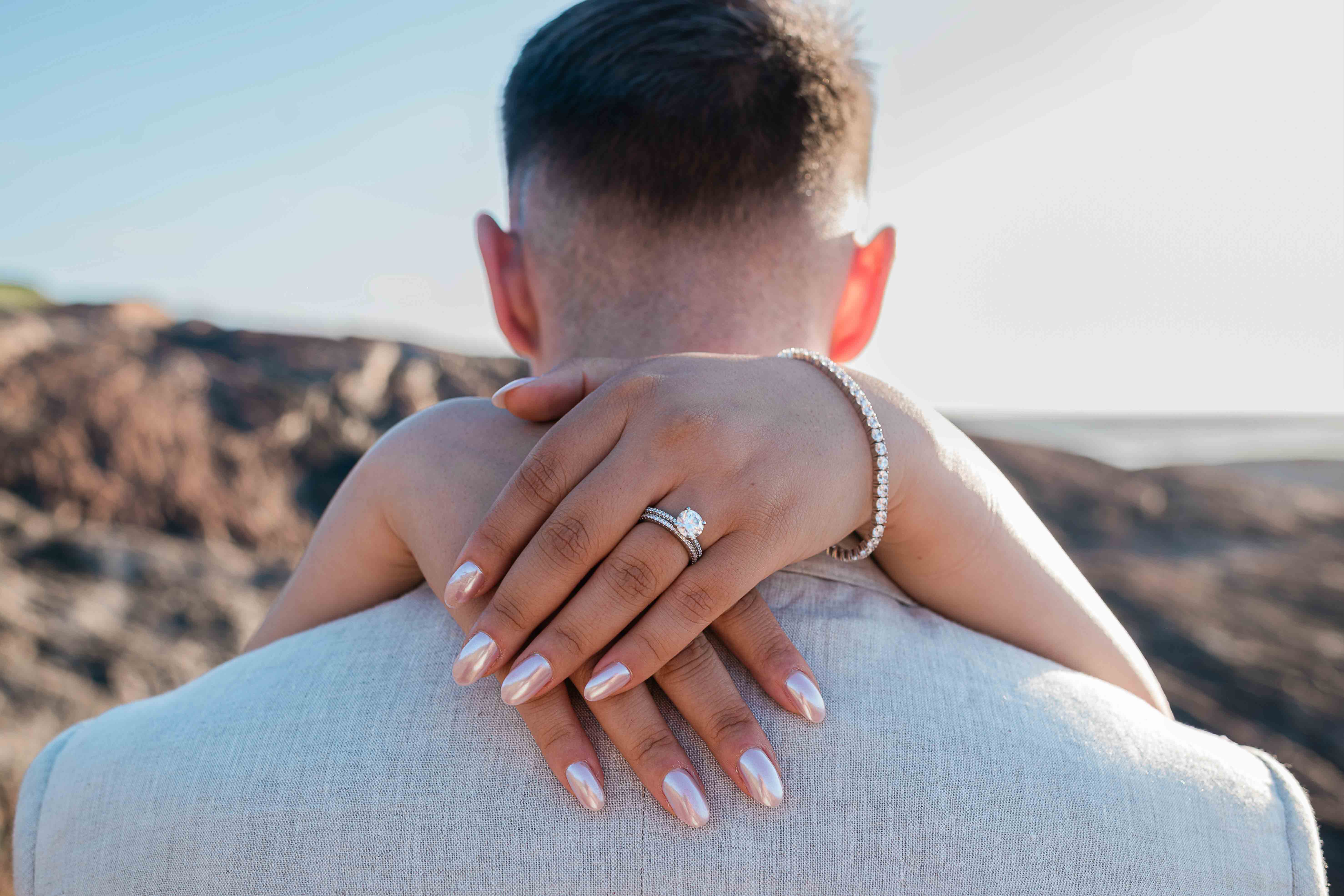 bride displays her new wedding ring with beautiful natural photo