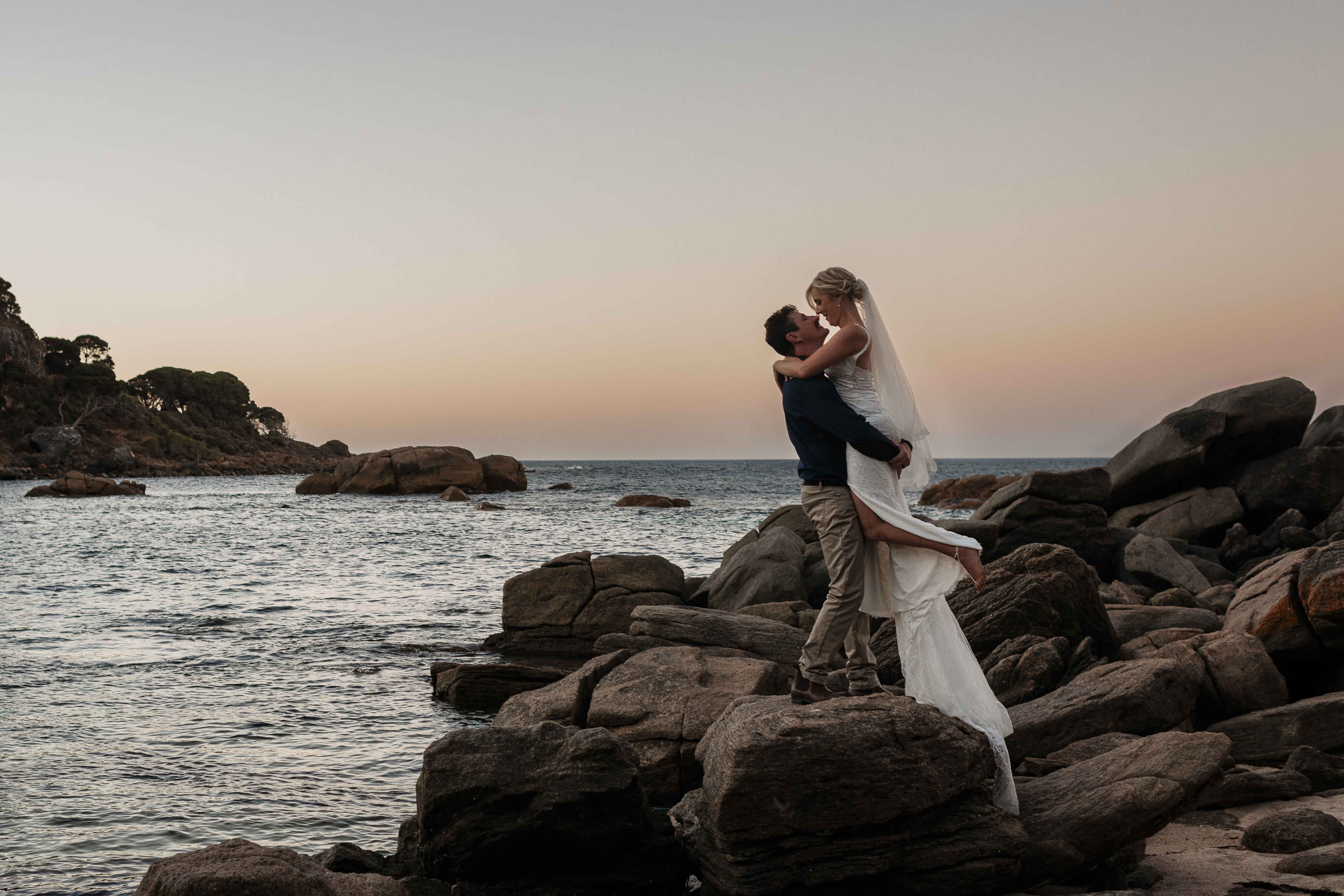 Couple at sunset on granite rocks, beach elopement Margaret River, South West WA, John Rice Photographer