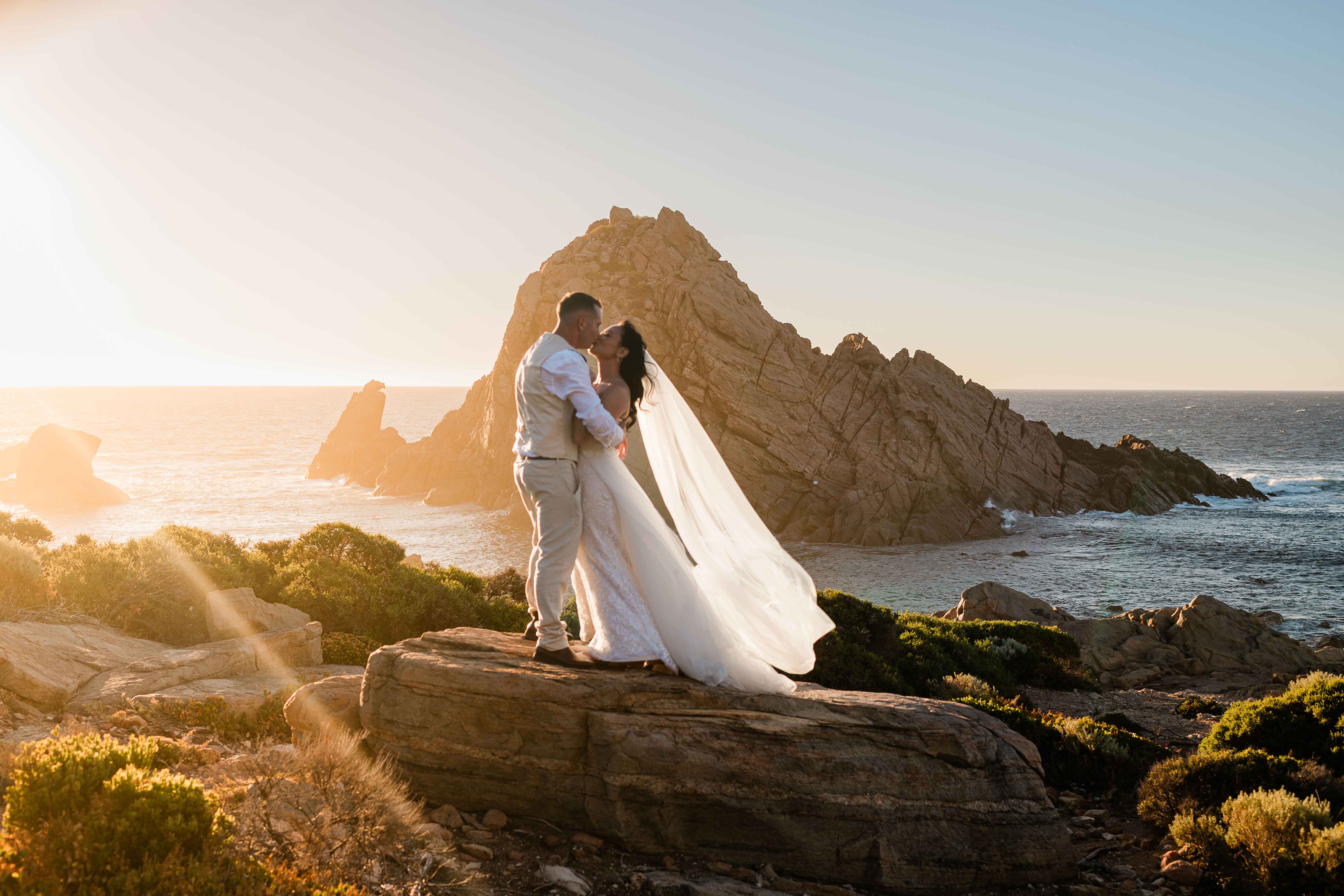 Couple kissing at golden hour, Sugarloaf Rock, Margaret River region, John Rice Photographer