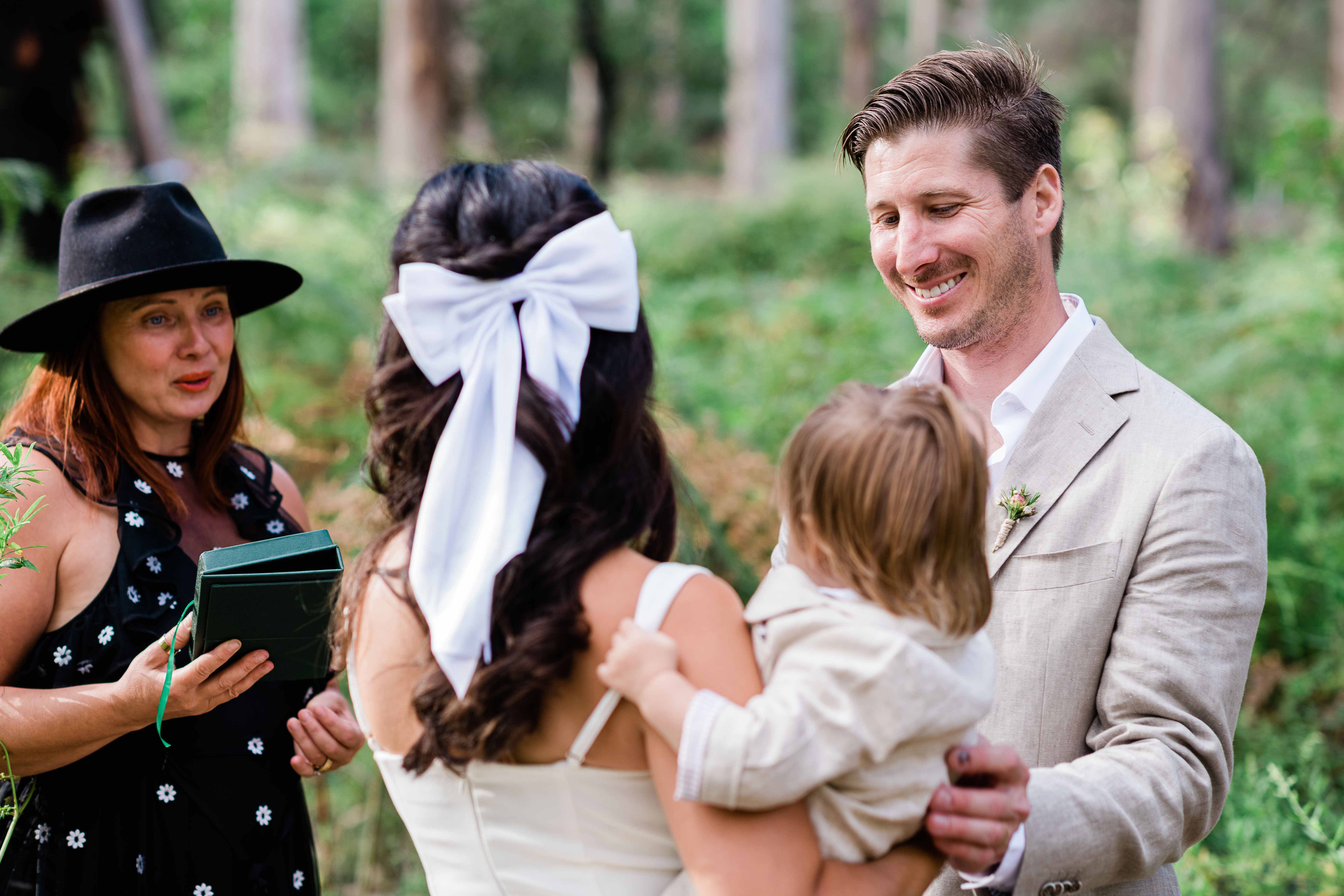 James and Sarah exchanging vows at Boranup Karri Forest with celebrant Kate during their Margaret River elopement