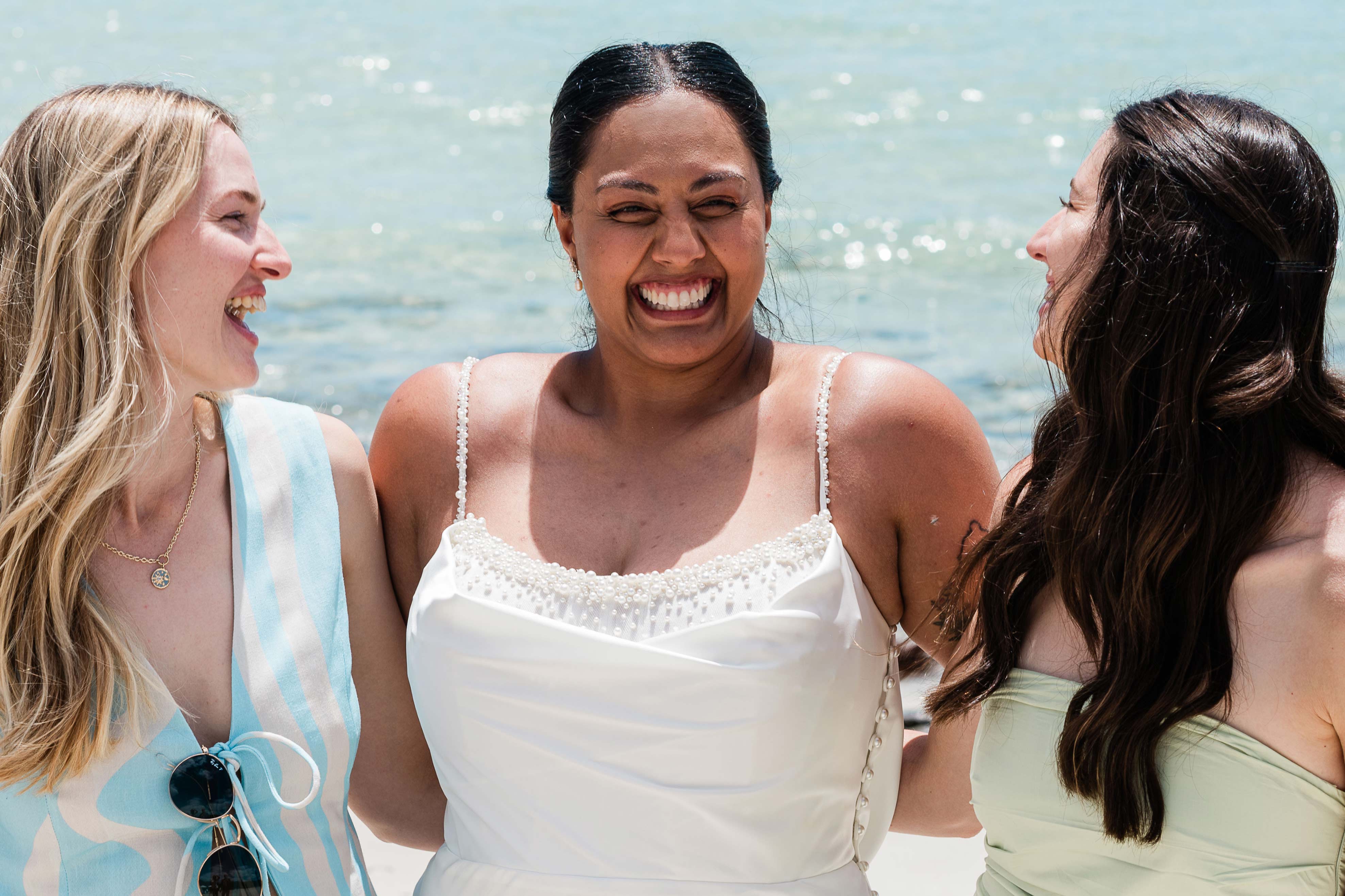 bride laughing with friends at a beach micro-wedding near Margaret River