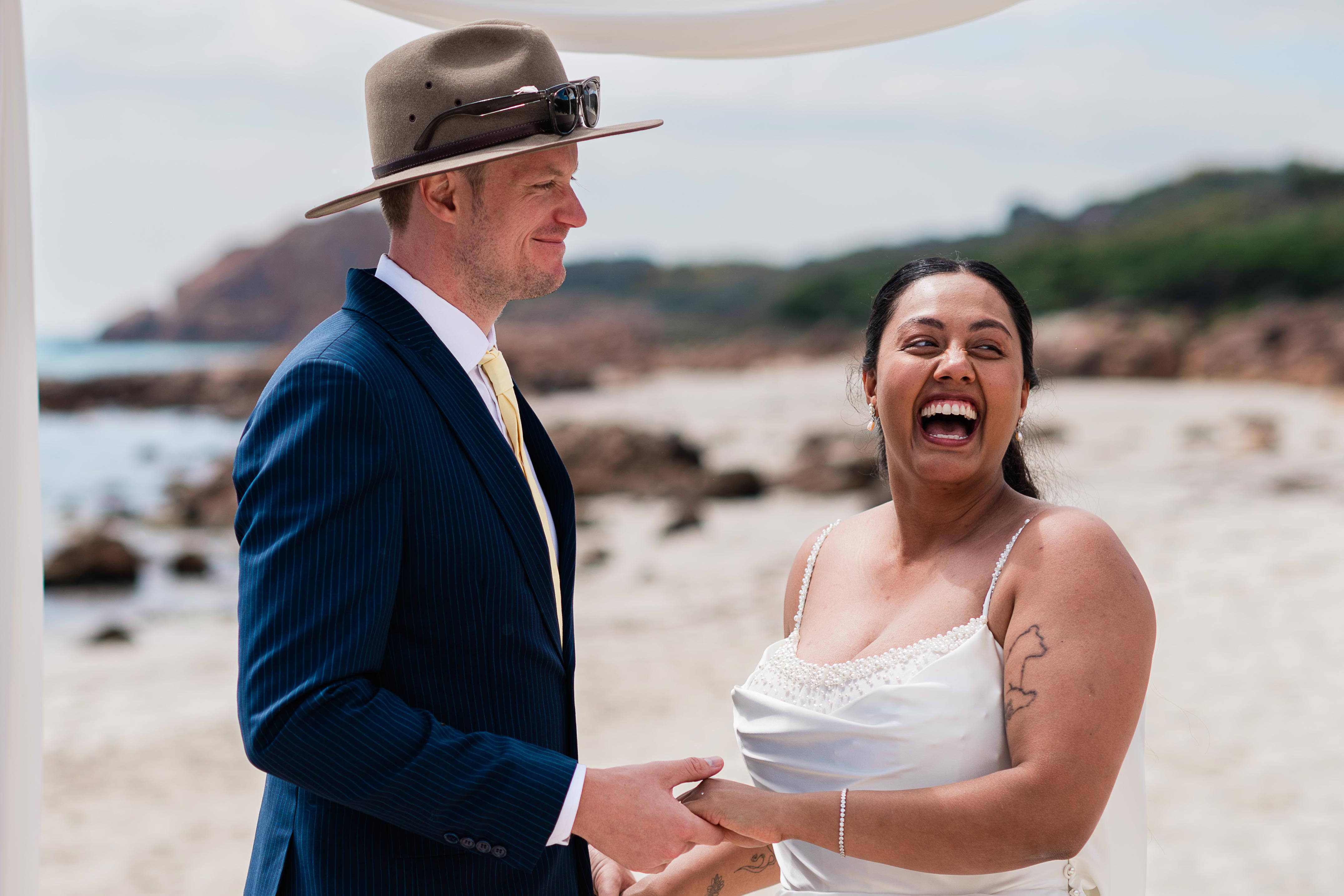 couple laughing during an intimate beach micro-wedding ceremony at Castle Rock, Dunsborough