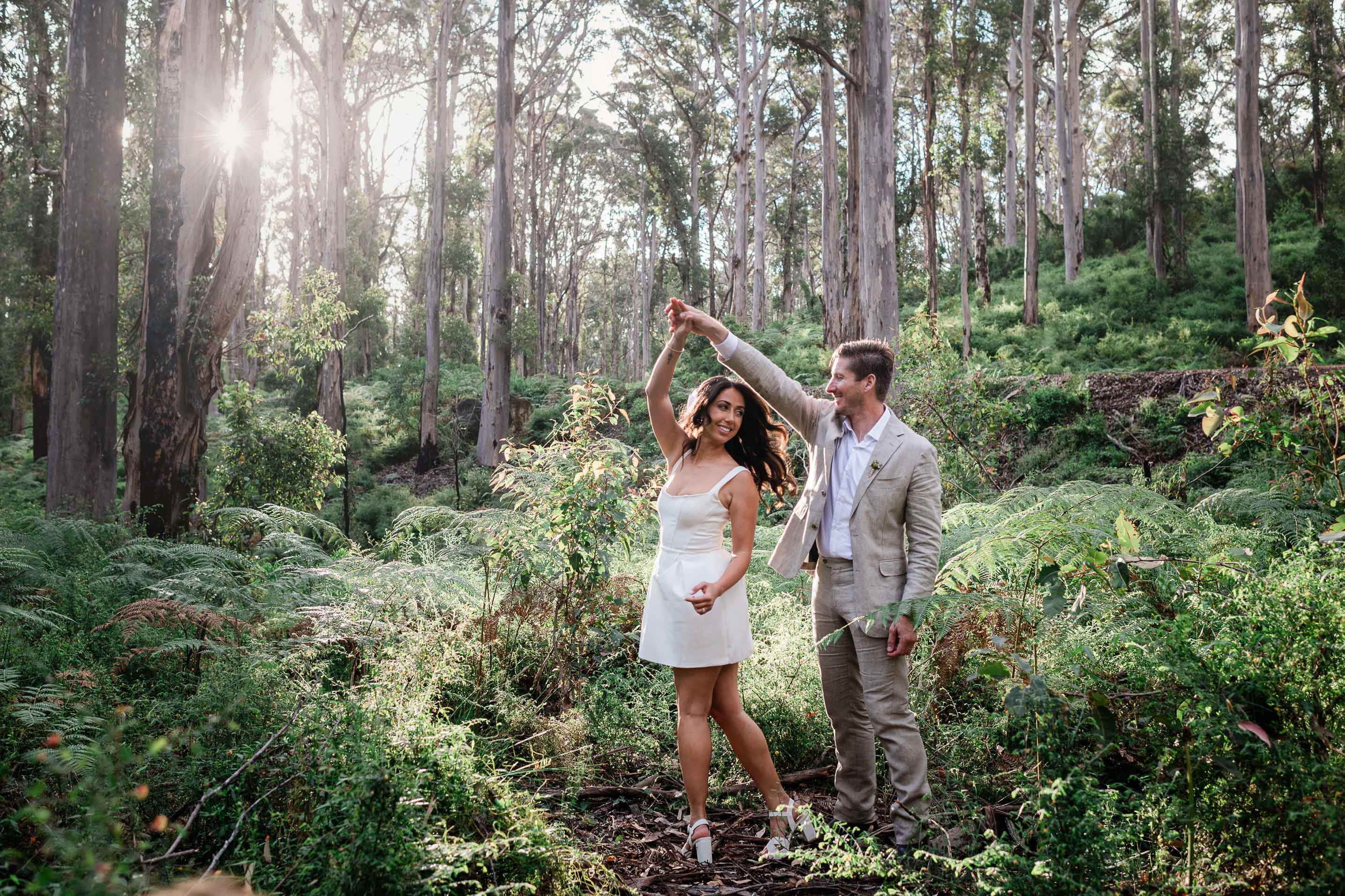 Boranup Forest elopement portrait, couple twirling among karri trees and tree ferns in Margaret River, photographed by John Rice
