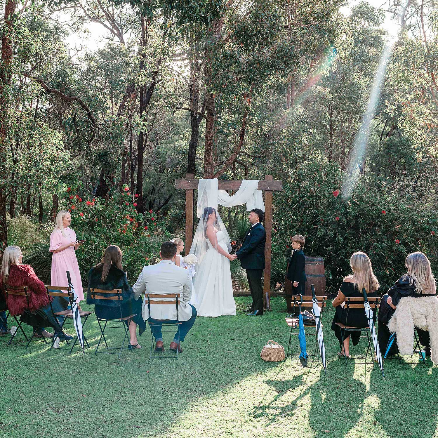 Intimate Bina Maya wedding ceremony on bushland lawn with celebrant and 9 family guests, Yallingup elopement
